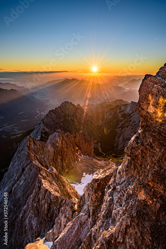 A beautiful and colorful sunrise on the summit of the highest mountain in Germany, Zugspitze at 2962m. 