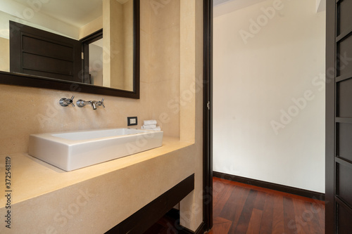 Fototapeta Naklejka Na Ścianę i Meble -  Interior design of house, home, villa, condo and apartment feature sink with towels, mirror and tap
