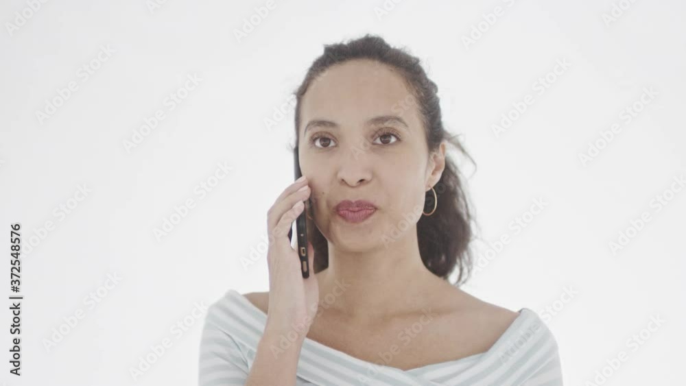 Attractive young serious brunette talks to someone via mobile phone and has heated discussion. 360 degree tracking arc shot in 4K. Attractive young serious brunette talks to someone via mobile phone and has heated discussion. 360 degree tracking arc shot in 4K.