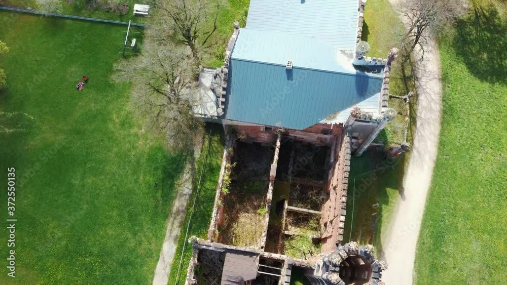 Aerial Shot of Destroyed Odzienas Castle in Latvia, Europe on a Beautiful Sunny Spring Day, Concept of Travel in Harmony on Countryside. Detail of the Ancient Castle. Stork Nest in the Tower