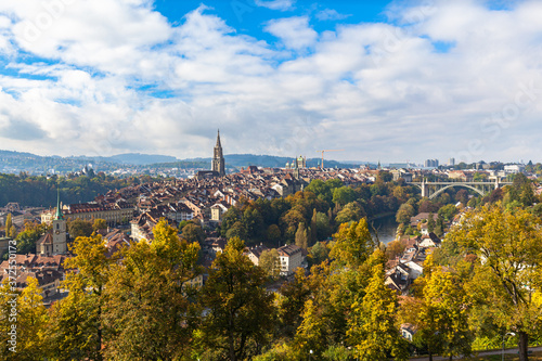 Beautiful view of Bern old town with the tower of Bern Minster (Münster) cathedral on a sunny autumn day with blue sky and cloud, Switzerland