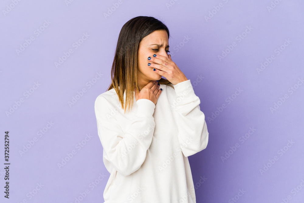 Young woman isolated on purple background suffers pain in throat due a virus or infection. Young woman isolated on purple background suffers pain in throat due a virus or infection.