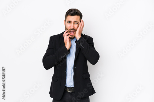 Young caucasian business man against a white background isolated whining and crying disconsolately.