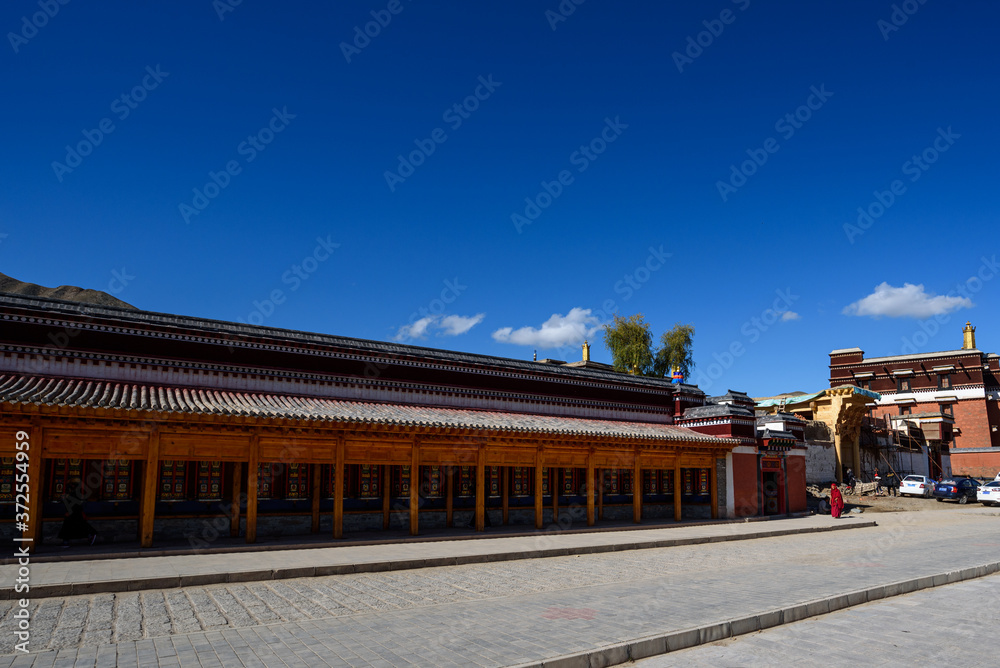 Tibetan prayer wheels at Labrang Monastery in Xiahe County, China.  Translation text written in sanskrit means 
