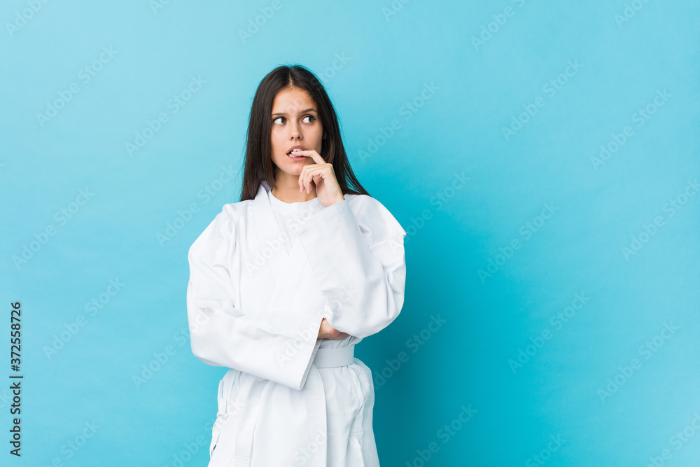Young karate woman relaxed thinking about something looking at a copy space. Young karate woman relaxed thinking about something looking at a copy space.