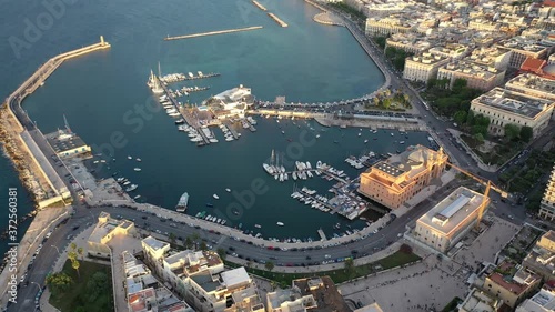 Beautiful panoramic aerial 4K video from flying drone at sunset to Bari Apulia City port boats and yachts Sea Coastline, Teatro Margherita, and Bari city skyline. Bari ,Apulia, Italy (Series) photo