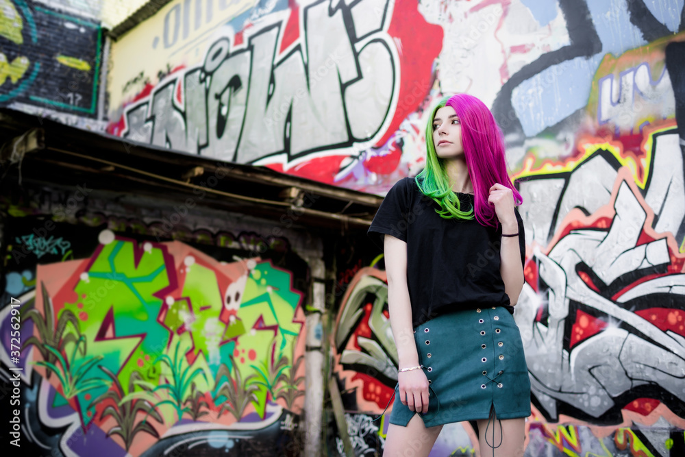 Close-up Fashion woman portrait of a girl with green - pink hair. Summer street fashion. Close-up Fashion woman portrait of a girl with green - pink hair. Summer street fashion.