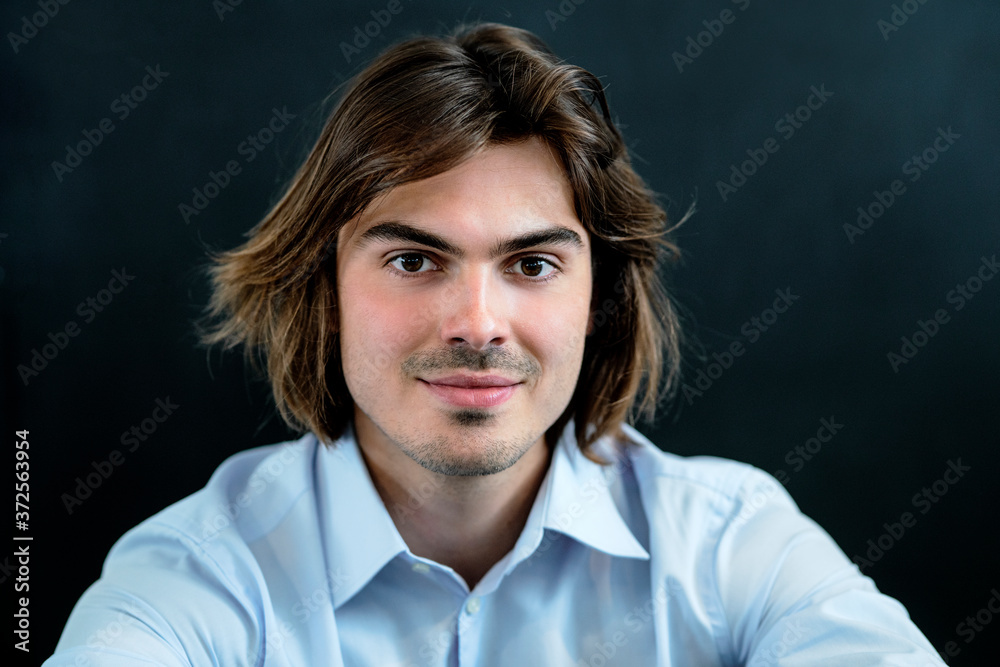 Close-up of smiling businessman against wall in coffee shop Close-up of smiling businessman against wall in coffee shop