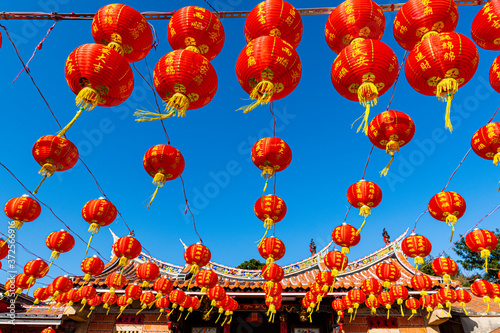 Taiwan, Kinmen, Shuitou Village, Red Chinese lanterns hanging against clear blue sky during Chinese New Year photo