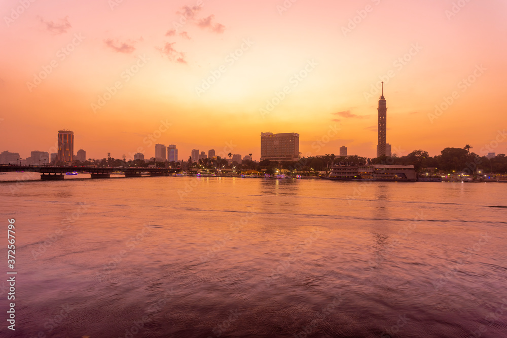 Egypt, Cairo, Cairo Tower on Gezira Island seen across river Nile at sunset Egypt, Cairo, Cairo Tower on Gezira Island seen across river Nile at sunset