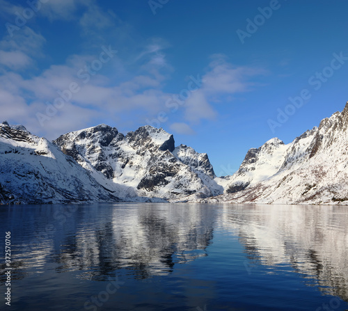 Beautiful reflection of winter mountains in Olenilsoya in Reine, Lofoten Islands, Norway © ALLA