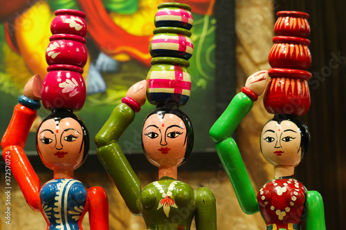 Hand Made Wooden Colorful Channapatna Ring Toys Of Traditional Cultural Indian Women In Ethnic Dress Carrying Water In Round Earthen Pitcher Ghada On Head