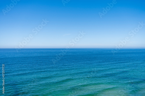 Beautiful blue green ocean seascape view with wave lines. Horizon line at sea and clear blue sky. Travel, vacation, holidays, relax feeling © Joao