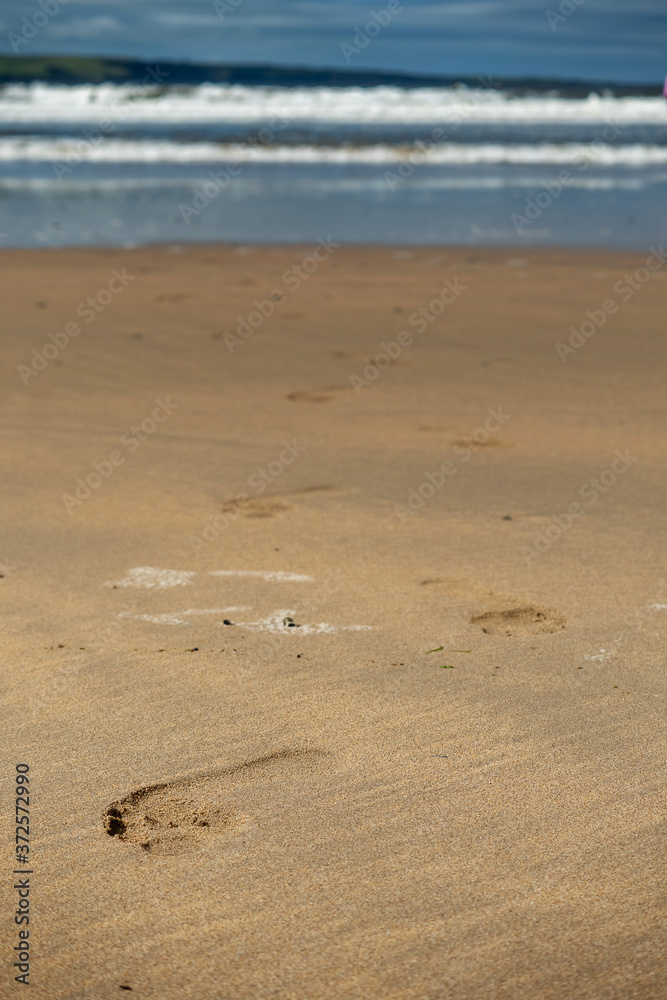 Foot prints on a yellow ocean sand. Foot prints on a yellow ocean sand.