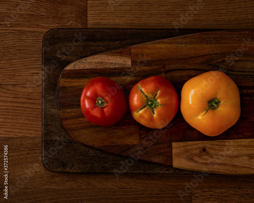 Tomatoes on cutting boards. photo