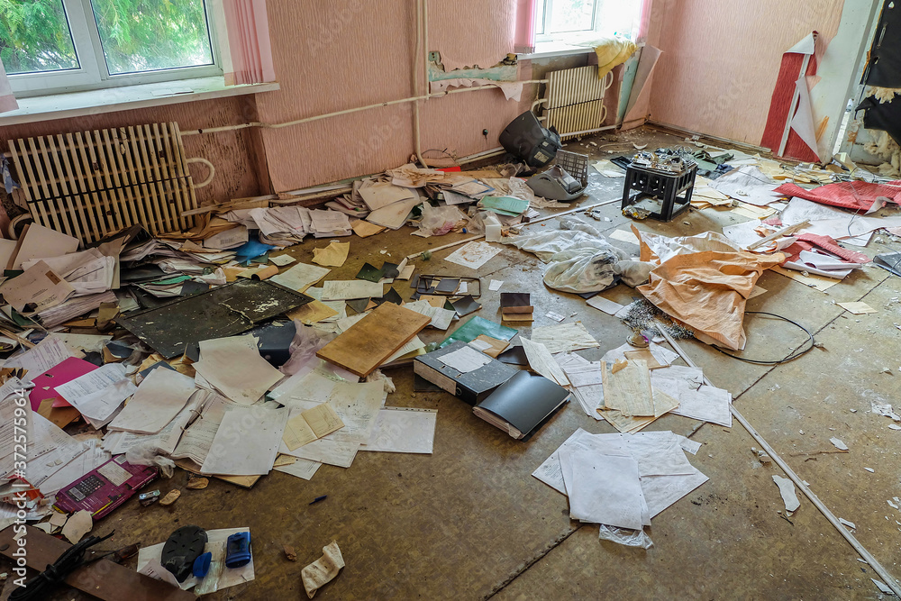 Room of an old abandoned building filled with trash on the floor Room of an old abandoned building filled with trash on the floor