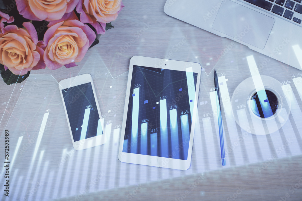 Double exposure of forex graph hologram over desktop with phone. Top view. Mobile trade platform concept.