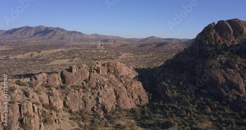 4K aerial drone video of African savanna hills, large red granite boulders range near B1 highway south of Windhoek in central highland of Namibia, southern Africa photo