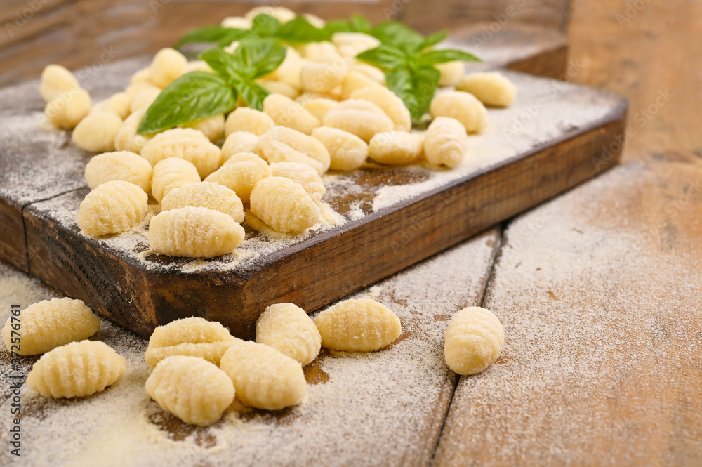 Gnocchi with potatoes. Traditional italian food from Rome, Sardinia, south of italy. Homemade gnocchi with parmesan, egg, cornmeal (semolina). On a wooden table. High quality photo. Above. Copy space Gnocchi with potatoes. Traditional italian food from Rome, Sardinia, south of italy. Homemade gnocchi with parmesan, egg, cornmeal (semolina). On a wooden table. High quality photo. Above. Copy space