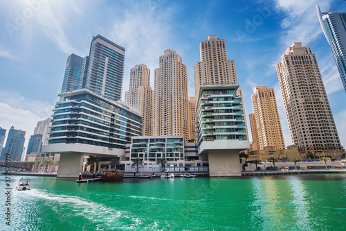 Dubai marina water canal with promenade and modern buildings, UAE. Luxury travel concept. © DedMityay