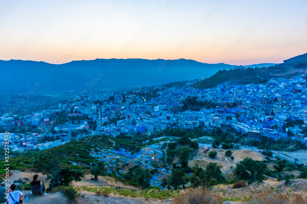 Obraz premium Beautiful sunset over the cityscape of Chefchaouen, the blue city of Morocco