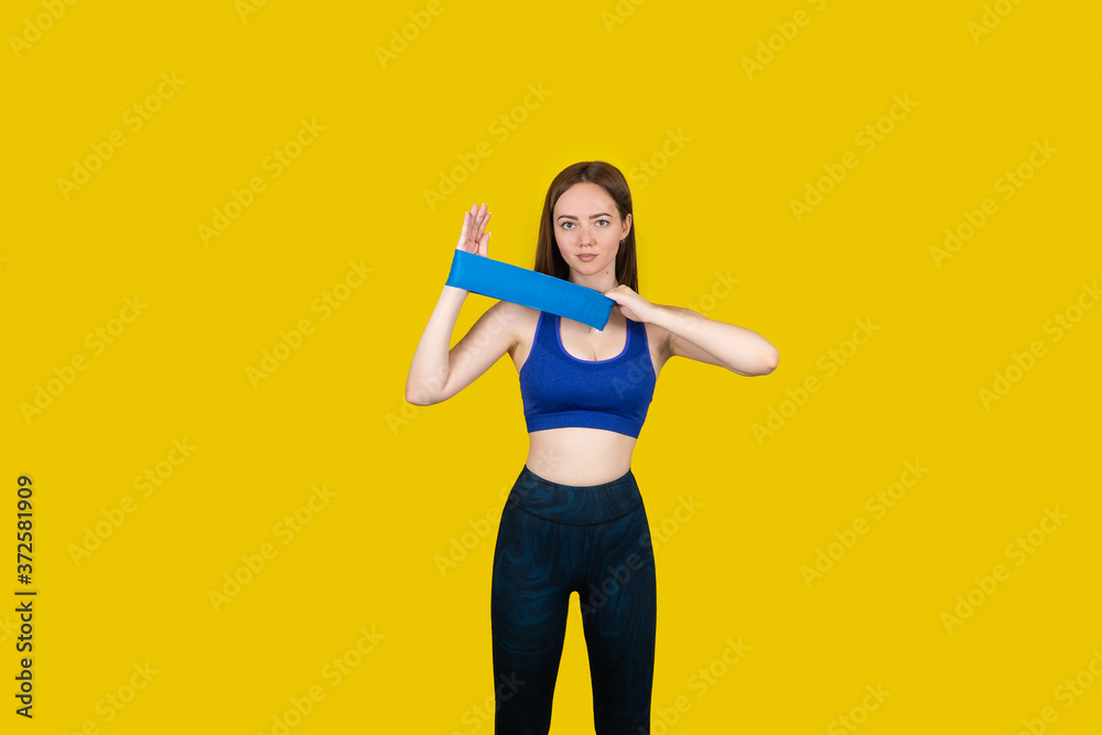 Girl in sports uniform with equipment on a yellow background Girl in sports uniform with equipment on a yellow background