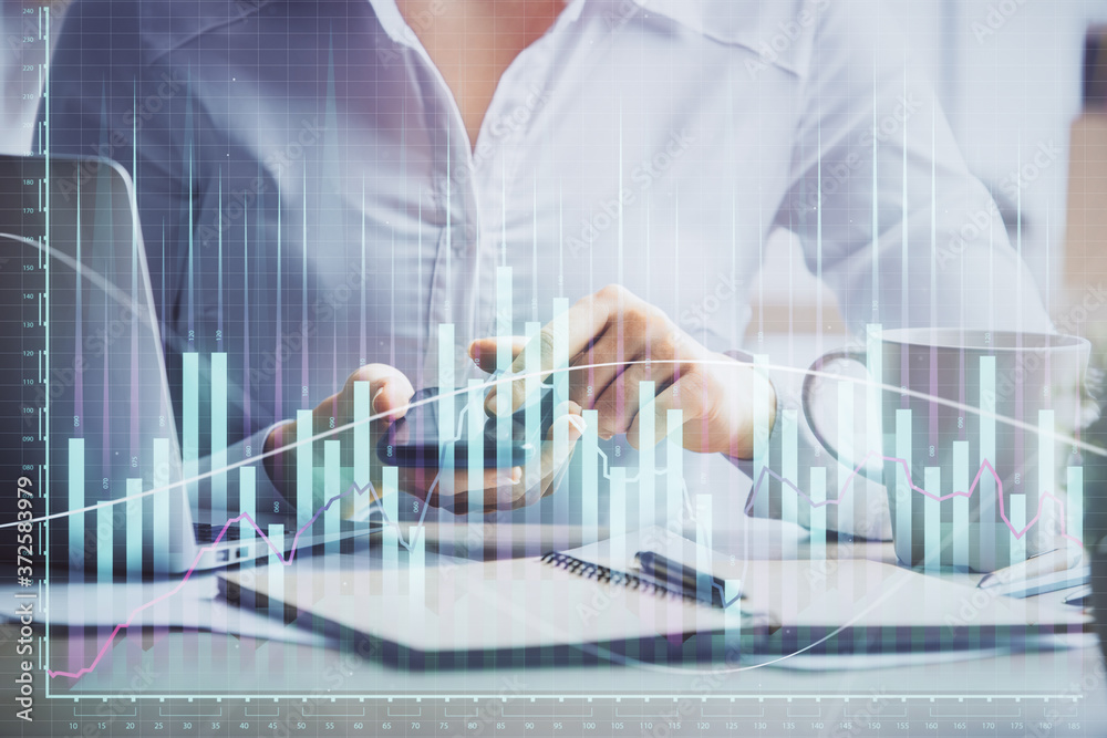 Double exposure of forex chart sketch hologram and woman holding and using a mobile device. Financial market concept. Double exposure of forex chart sketch hologram and woman holding and using a mobile device. Financial market concept.