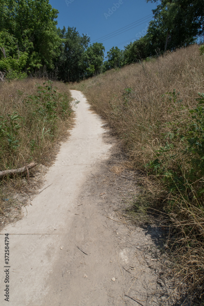 a concrete trail up a short but steep hill a concrete trail up a short but steep hill