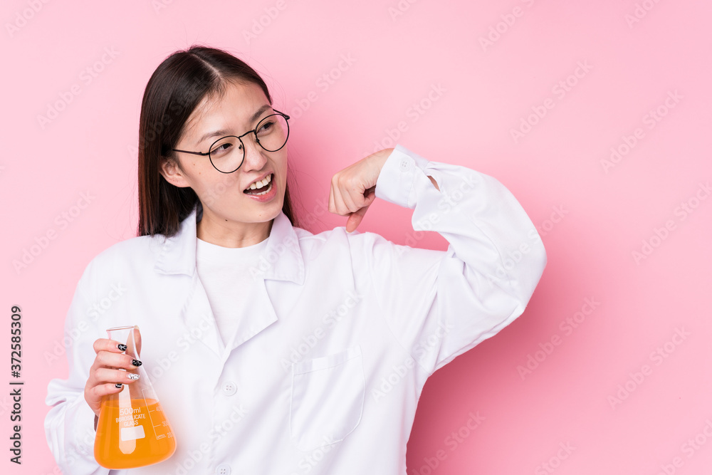 Young chinese scientific woman isolated raising fist after a victory, winner concept. Young chinese scientific woman isolated raising fist after a victory, winner concept.
