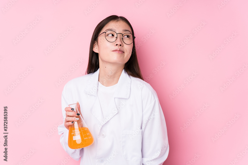Young chinese scientific woman isolated dreaming of achieving goals and purposes Young chinese scientific woman isolated dreaming of achieving goals and purposes