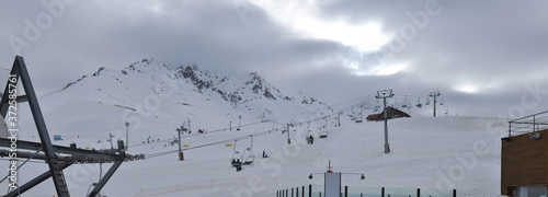 Panoramic landscape of Las Leñas ski resort, with ski lifts in the foreground and clouds in the background