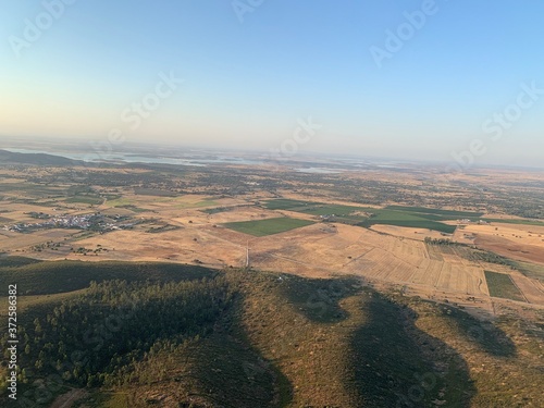 Hot air balloon flight at sunrise, Aerial View over the great Alqueva lake, in Alentejo, Portugal