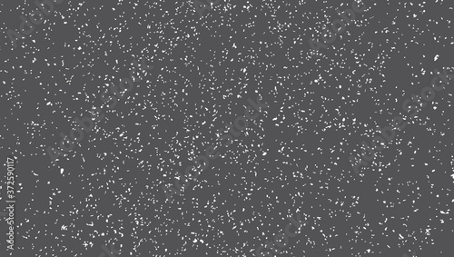 Blacktop surface texture. Small white spots of irregular shape on a dark gray background.