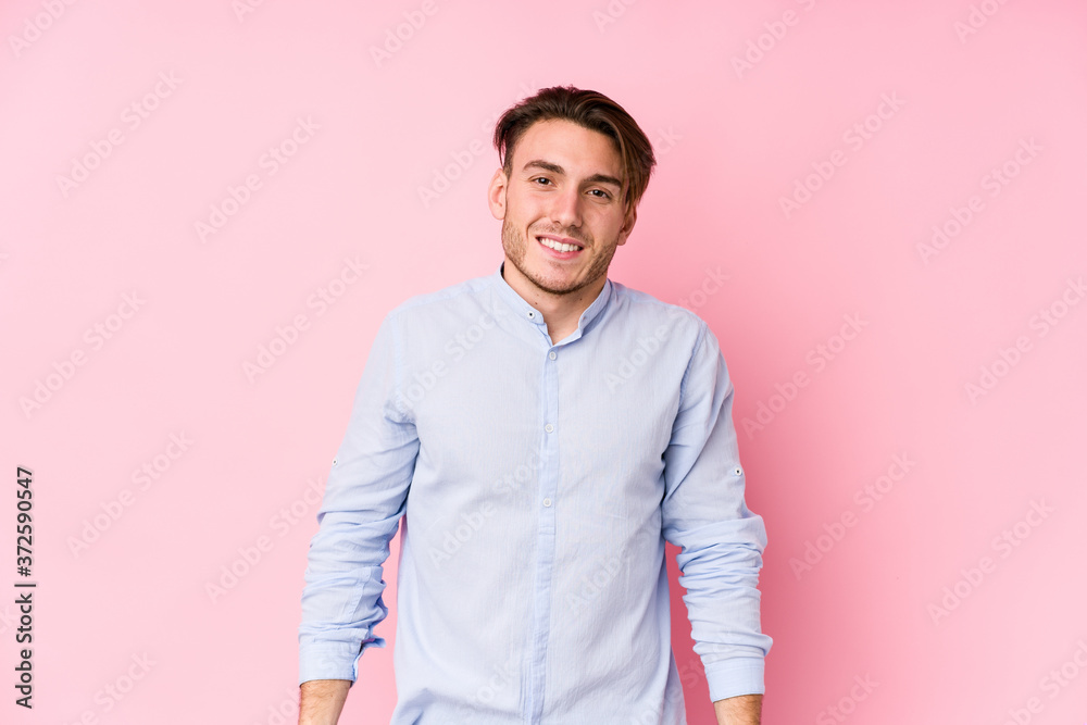 Young caucasian man posing in a pink background isolated laughs and closes eyes, feels relaxed and happy. Young caucasian man posing in a pink background isolated laughs and closes eyes, feels relaxed and happy.