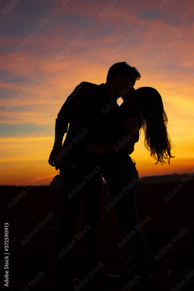 silhouette of a couple on a sunset background