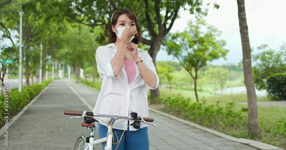 female wearing mask with bicycle female wearing mask with bicycle