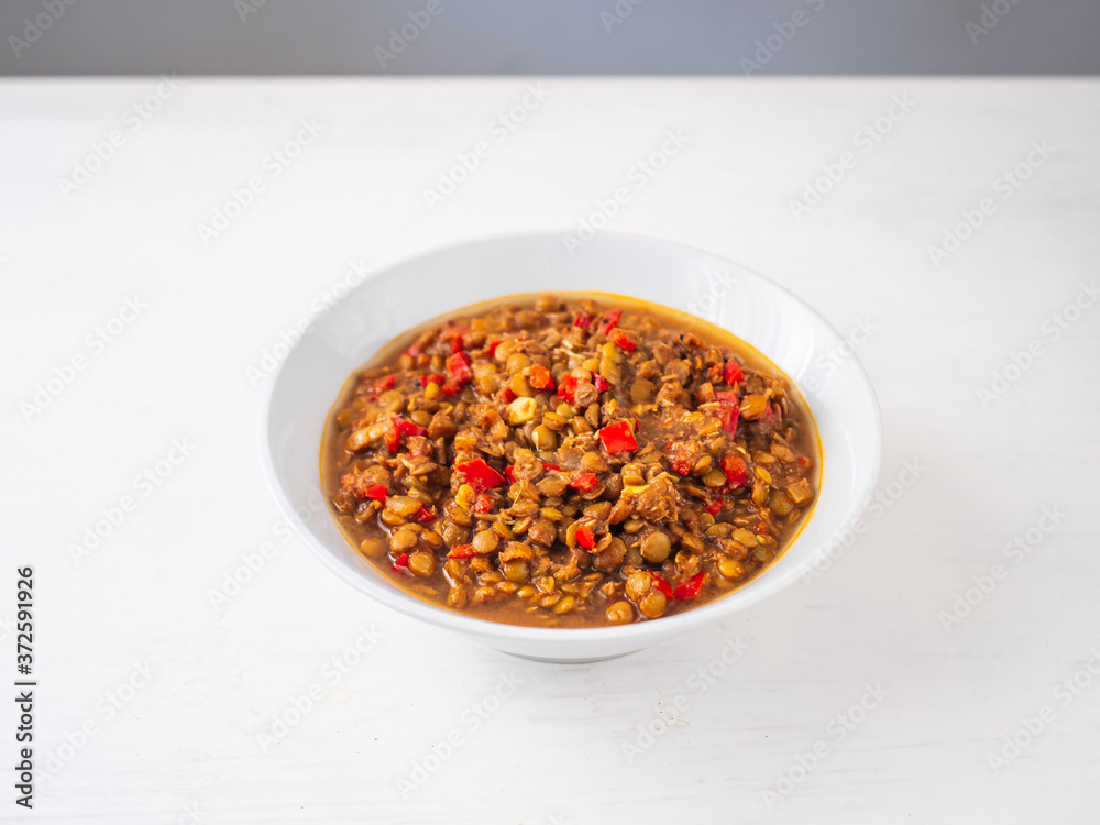 Vegetarian Vegan Indian Food: Lentil Dal Stew Bowl with Vegetables on a White Background Vegetarian Vegan Indian Food: Lentil Dal Stew Bowl with Vegetables on a White Background