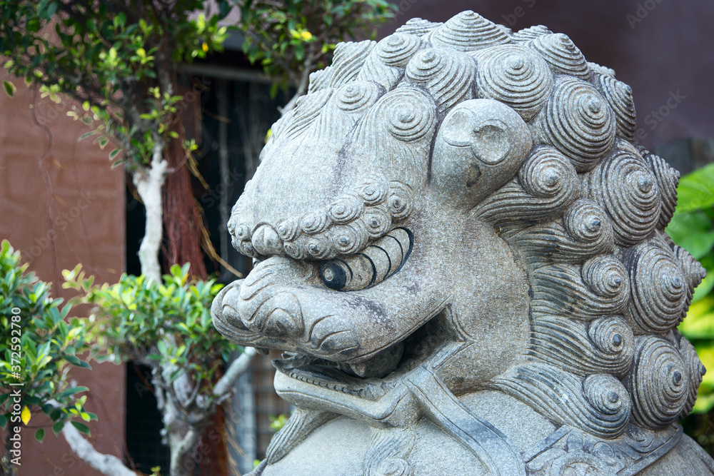 statue of a mythological lion from the Buddhist tradition at the entrance to the pagoda