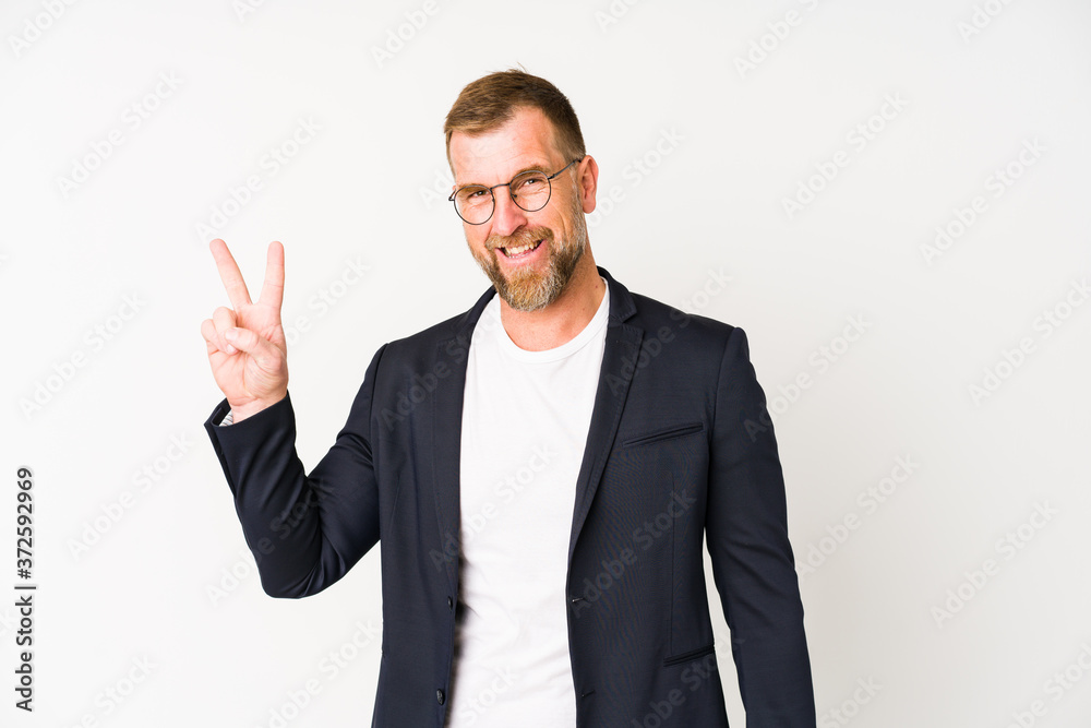 Senior business man isolated on white background joyful and carefree showing a peace symbol with fingers. Senior business man isolated on white background joyful and carefree showing a peace symbol with fingers.