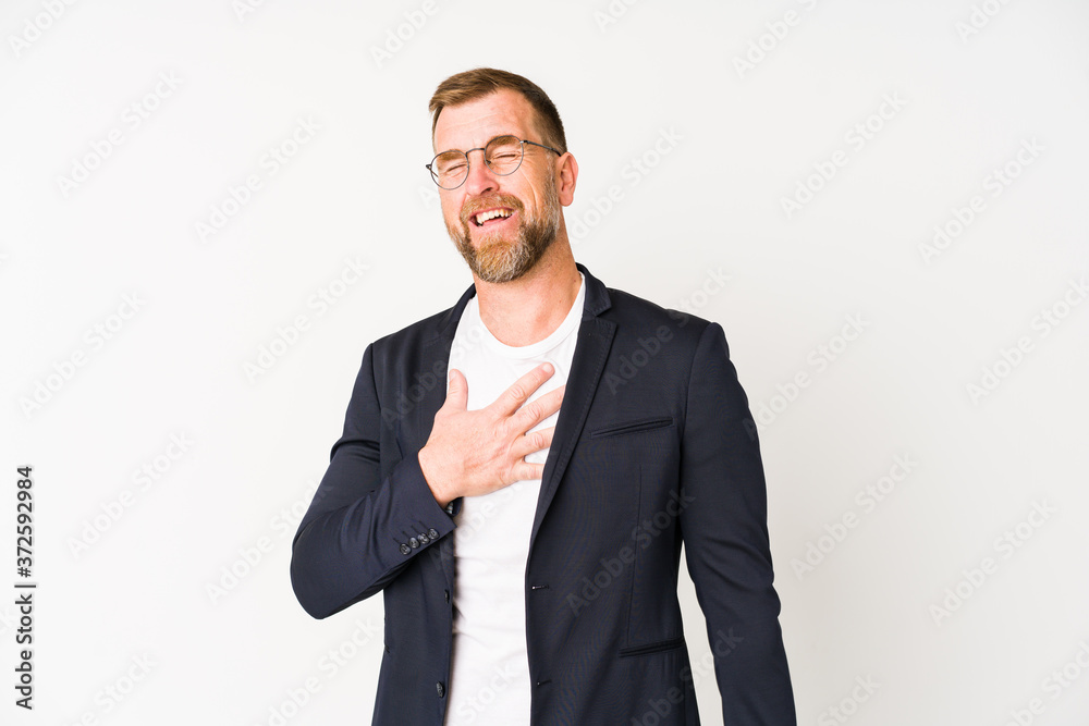 Senior business man isolated on white background laughs out loudly keeping hand on chest. Senior business man isolated on white background laughs out loudly keeping hand on chest.