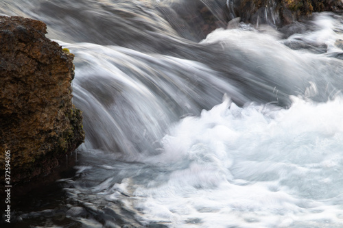 water flowing over rocks, slow motion of moving water.