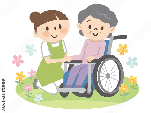 車椅子のシニアの女性と介護スタッフ