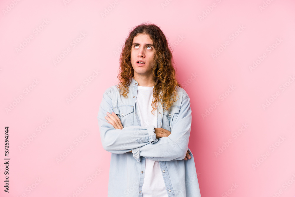 Long hair man posing isolated tired of a repetitive task. Long hair man posing isolated tired of a repetitive task.