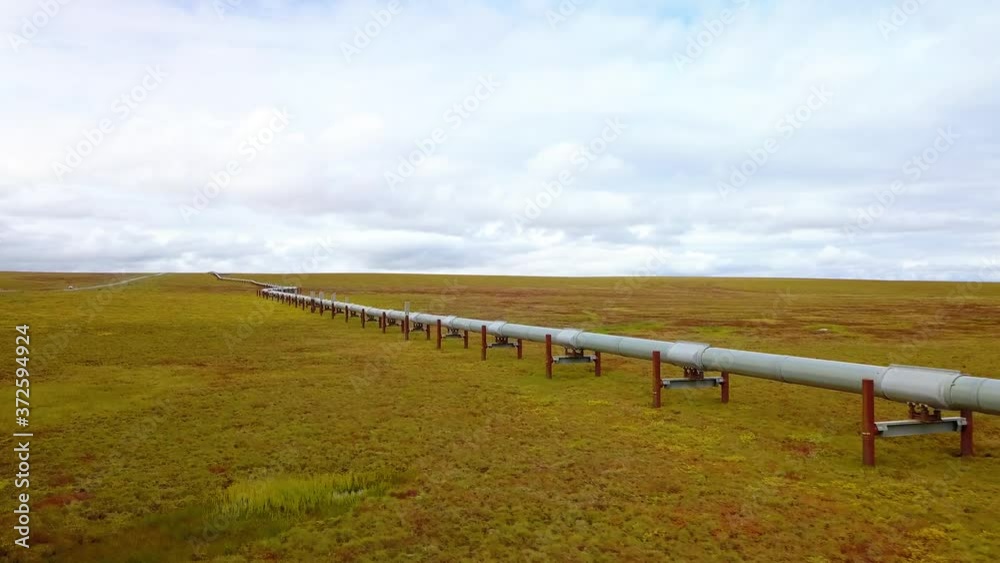 Aerial view of the Alyeska pipeline, oil transportation pipe following the Dalton Highway, cloudy day, in Alaska, USA Aerial view of the Alyeska pipeline, oil transportation pipe following the Dalton Highway, cloudy day, in Alaska, USA