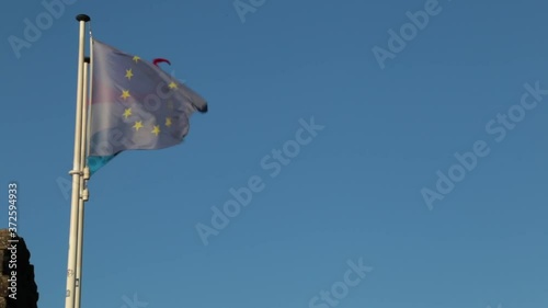 Flags of Luxembourg and European Union flying in unison at sunset photo