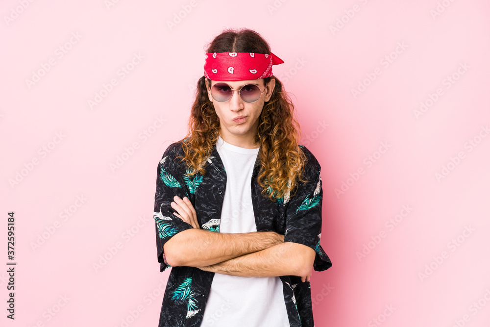 Young hippie caucasian man isolated frowning face in displeasure, keeps arms folded. Young hippie caucasian man isolated frowning face in displeasure, keeps arms folded.