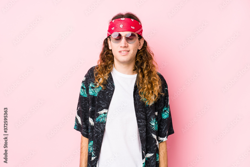 Fototapeta premium Young hippie caucasian man isolated laughs and closes eyes, feels relaxed and happy.