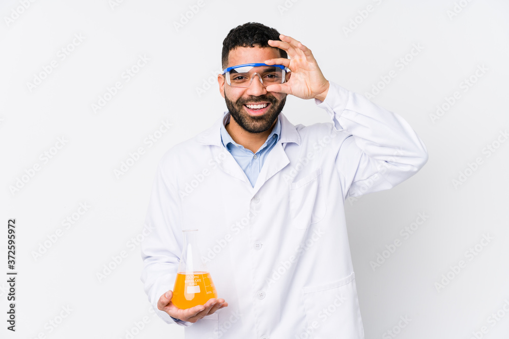 Young arabian chemical man isolated excited keeping ok gesture on eye. Young arabian chemical man isolated excited keeping ok gesture on eye.