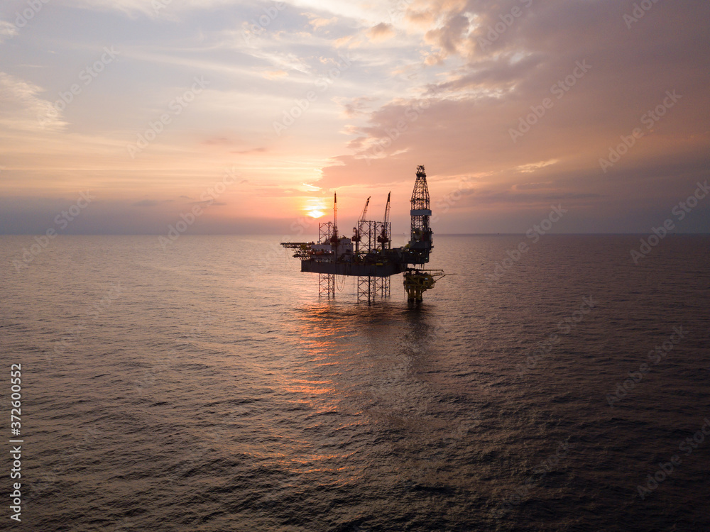 Aerial view offshore jack up rig at the offshore location during sunset