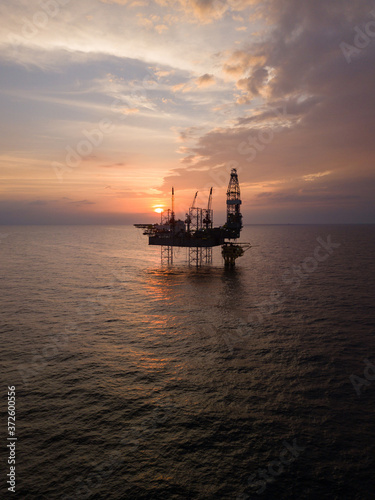 Aerial view offshore jack up rig at the offshore location during sunset